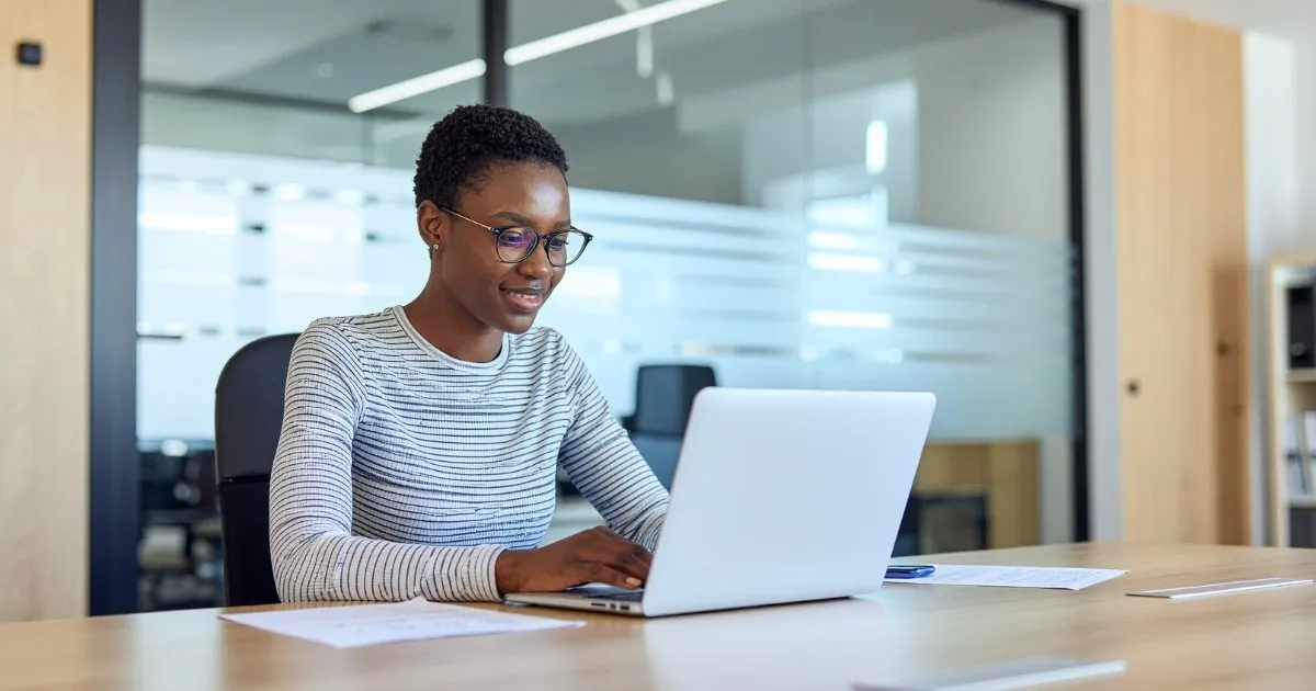 A professional using everyday digital tools as AI becomes embedded in daily business workflows